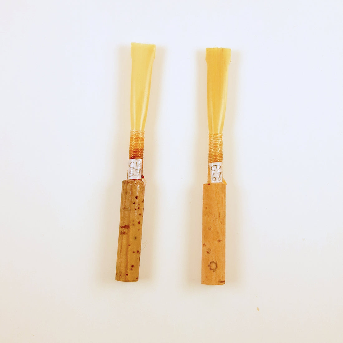 Two tied oboe reed blanks showing their individual serial numbers